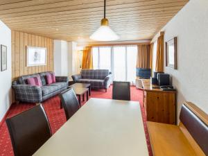 a living room with a table and chairs at Apartment Chalet Abendrot apARTments-26 by Interhome in Grindelwald
