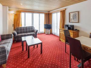 a living room with a couch and a table at Apartment Chalet Abendrot apARTments-26 by Interhome in Grindelwald