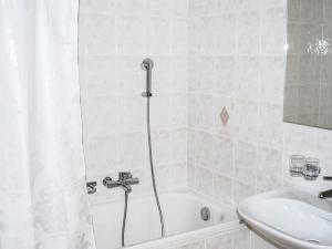 a bathroom with a shower and a tub and a sink at Apartment Residenza Corallo-22 by Interhome in Ascona +7 photos