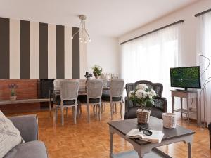 sala de estar con mesa, sillas y TV en Apartment Large Suite by Interhome, en Ascona