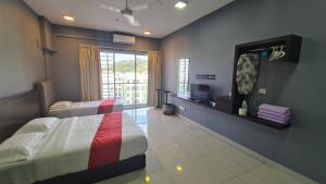 a bedroom with a bed and a mirror and a tv at Aeropod KK Studio Unit 09 Near Airport And City Free Parking in Kota Kinabalu