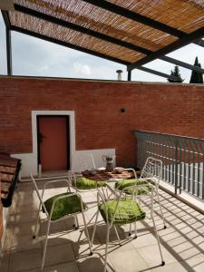 a patio with chairs and a table and a brick wall at Al Canaiolo in Strada