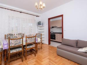 a living room with a table and a couch at Apartment Balota by Interhome in Viganj