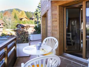 a patio with a table and chairs on a balcony at Apartment Le Bristol A16 by Interhome in Villars-sur-Ollon