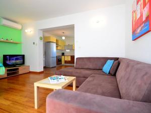 a living room with a couch and a coffee table at Apartment Cvita-1 by Interhome in Sovlje