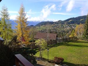 a backyard with a fence and a view of a mountain at Apartment Le Bristol A16 by Interhome in Villars-sur-Ollon