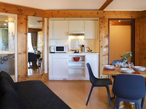 a kitchen and dining room with a table and chairs at Apartment Le Bristol A16 by Interhome in Villars-sur-Ollon