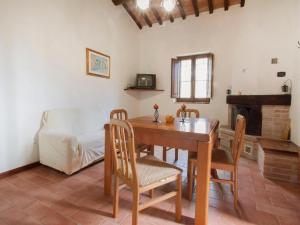a dining room with a table and chairs and a couch at Holiday Home Ca' di Bacco-1 by Interhome in Nestore