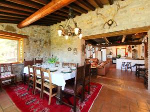 a dining room and living room with a table at Holiday Home Casale Verciano by Interhome in Parrano