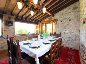 a dining room with a white table and chairs at Holiday Home Casale Verciano by Interhome in Parrano