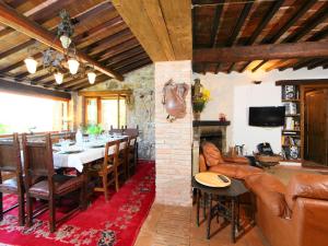 a living room with a table and a dining room at Holiday Home Casale Verciano by Interhome in Parrano +25 photos
