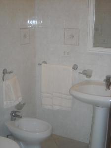Baño blanco con aseo y lavamanos en b&b Bellavista, en Castro di Lecce