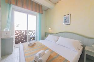 Postel nebo postele na pokoji v ubytování Hotel Cavalli + 13 fotografií