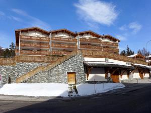a large building with stairs on the side of it at Apartment Antares R05 by Interhome in Crans-Montana