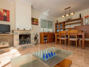 a living room with a table and a fireplace at Holiday Home Juan by Interhome in Segur de Calafell