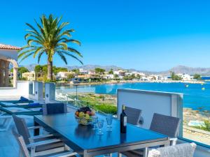 a dining table with a view of the water at Villa Can Verd by Interhome in Alcudia