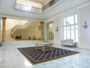 a large room with a table on a rug at Apartment Carlton-1 by Interhome in Biarritz