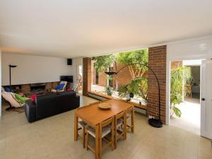 a living room with a table and a couch at Holiday Home Palmeras by Interhome in Creixell