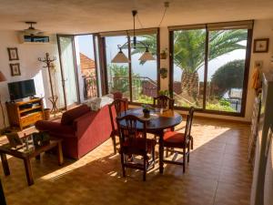 a living room with a table and a couch at Holiday Home Titi in Fuencaliente de la Palma