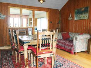 a living room with a table and a couch at Holiday Home Fiskavaig by Interhome in Fiskavaig