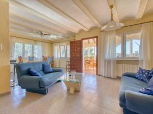 a living room with two blue couches and a table at Holiday Home Flamenc by Interhome in Jávea