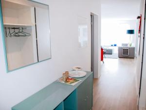 a kitchen with a blue counter and a white wall at Apartment LaVille A-3-4 by Interhome in Locarno