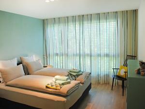 - une chambre avec un grand lit et une grande fenêtre dans l'établissement Apartment LaVille A-3-4 by Interhome, à Locarno