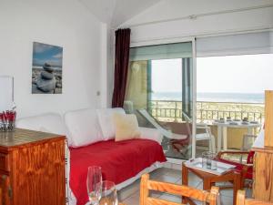 a living room with a bed and a view of the ocean at Apartment les Goelands by Interhome in Mimizan-Plage