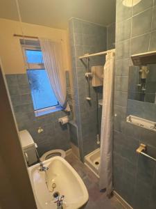 a bathroom with a sink and a toilet and a shower at Highbury Hotel in Blackpool +30 photos