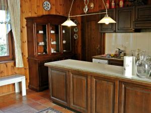 a kitchen with wooden cabinets and a counter top at Holiday Home Rustika by Interhome in Obermieger