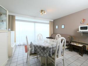 a kitchen and dining room with a table and chairs at Apartment Residentie Astrid-1 by Interhome in Bredene