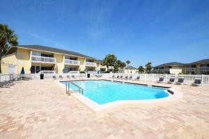 a swimming pool in front of a building at Sandpiper Cove by Panhandle Getaways in Destin