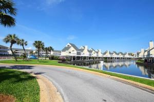 a winding road next to a river with houses at Sandpiper Cove by Panhandle Getaways in Destin