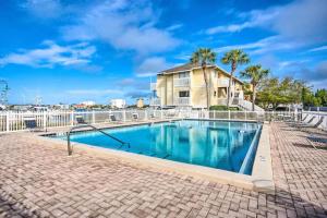 a swimming pool with a fence and a house at Sandpiper Cove by Panhandle Getaways in Destin
