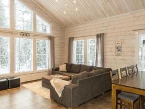 a living room with a couch and a table at Holiday Home Atrin suvanto b by Interhome in Levi