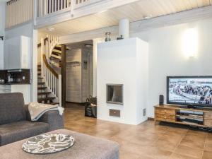 a living room with a couch and a tv at Holiday Home Atrin suvanto b by Interhome in Levi