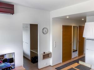 a living room with a clock on the wall at Holiday Home Tahkovuori chalet b 406 by Interhome in Tahkovuori