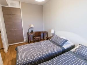 a bedroom with two beds and a desk with a chair at Holiday Home Ylläs chalets a202 by Interhome in Ylläs