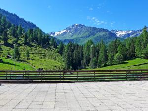 a wooden fence with a view of a mountain at Apartment Rosablanche 205 by Interhome in Siviez