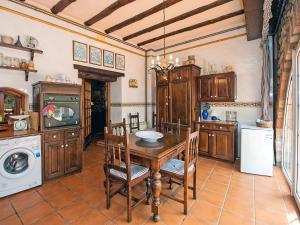a kitchen with a table and a stove and a dishwasher at Holiday Home Can Trullas by Interhome in Viladecaballs