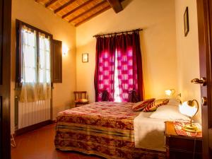 a bedroom with a bed and a red window at Apartment Borgo Fontana-2 by Interhome in Cerreto Guidi