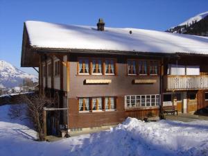 a house with snow on the roof of it at Apartment Bauernhaus Uf dr Flue by Interhome in Achseten