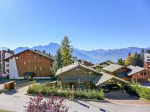 a group of buildings with mountains in the background at Apartment La Bercière 21 by Interhome in Villars-sur-Ollon