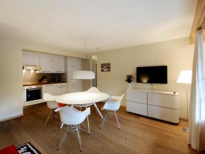 a kitchen and dining room with a table and chairs at Apartment Gade A by Interhome in Lenk