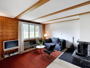 sala de estar con sofá y TV en Apartment Lischmatte A by Interhome en Lenk
