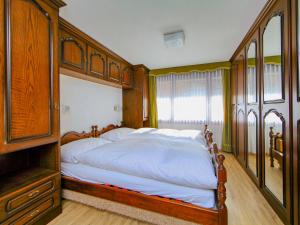 1 dormitorio con 1 cama grande con marco de madera en Apartment Zen Stecken A by Interhome, en Zermatt