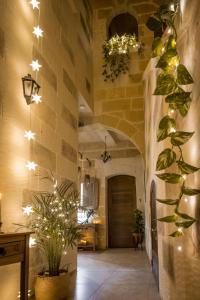 a large christmas tree in the middle of a room at Sweet Life Gozo in Santa Luċija