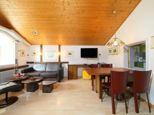 a living room with a couch and a table at Apartment Ringstrasse - Utoring-46 by Interhome in Leukerbad
