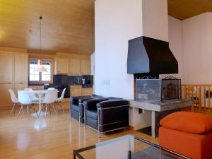 a living room with a couch and a fireplace at Chalet Bühlweidli by Ferienlenk in Lenk