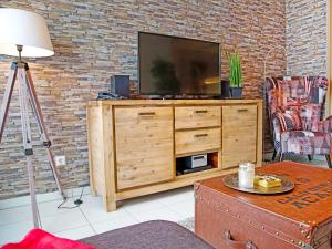 a living room with a television on a wooden dresser at Apartment Witthuus-Juist by Interhome in Norddeich